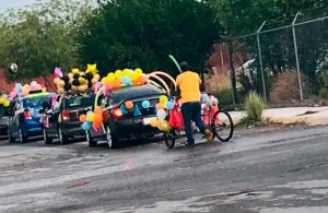 Padre expresa amor a su hijo adornando su triciclo para participar en caravana escolar